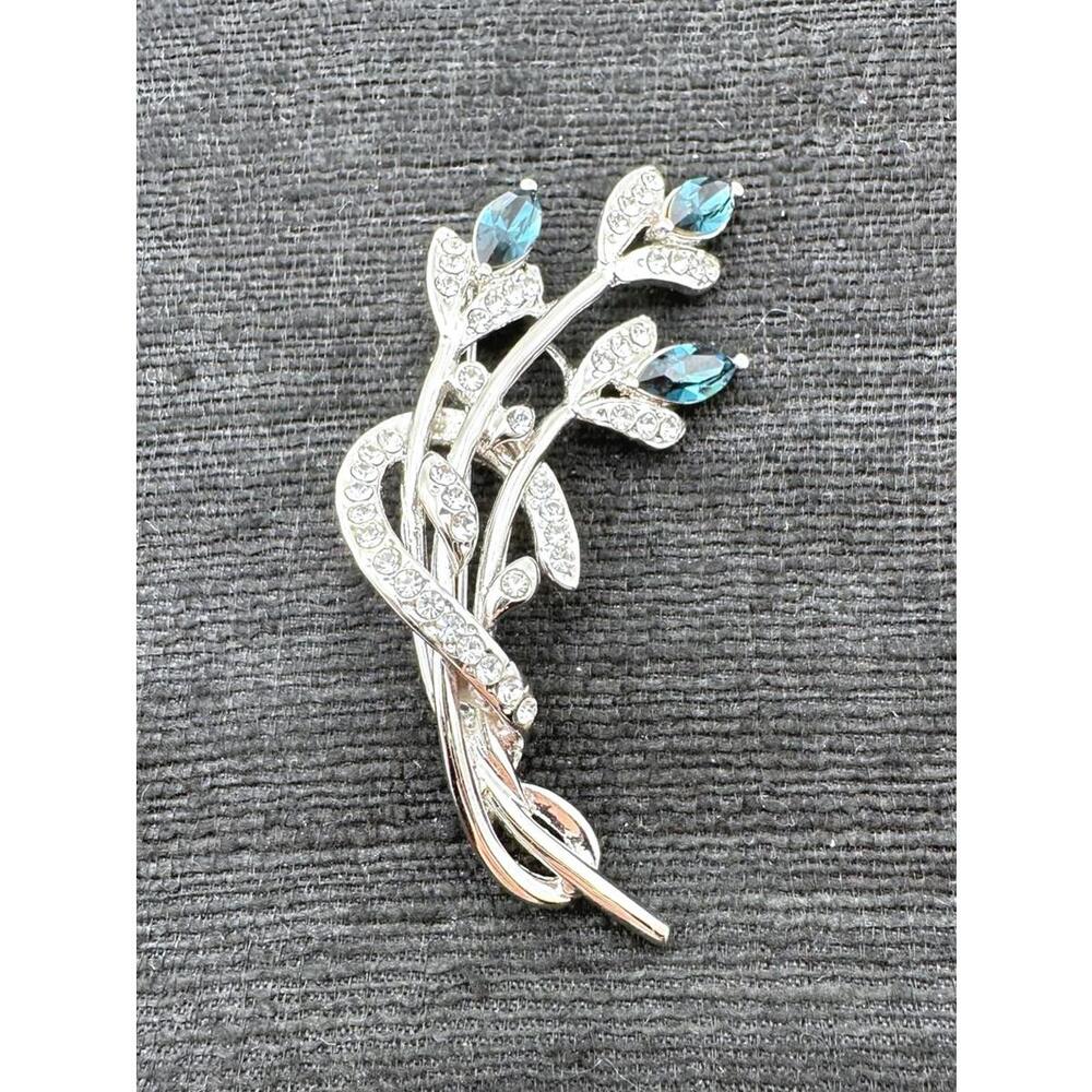 Elegant Silver Floral Brooch with Blue Stones